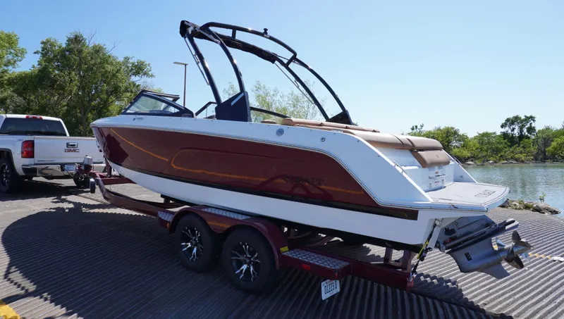 Slide: The Image of 2024 Cobalt CS23 boat on trailer near water, ready for launch. - 4