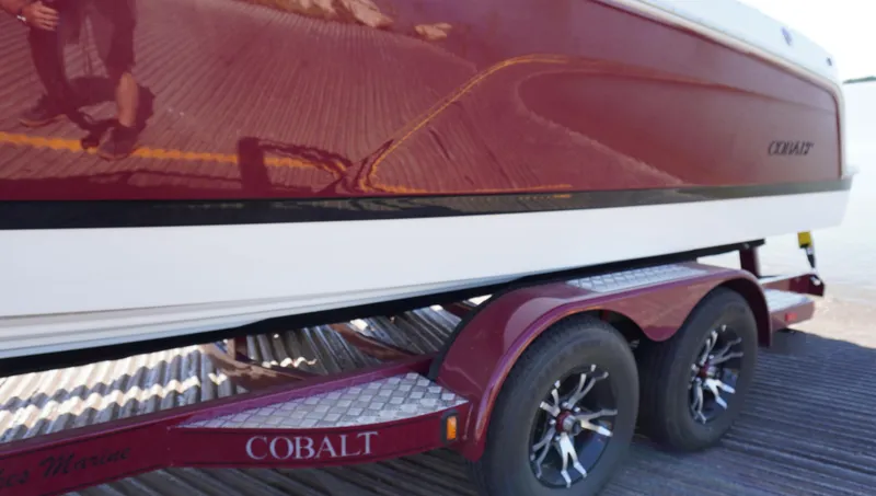 Slide: The Image of 2024 Cobalt CS23 boat on a red trailer, side view. - 5