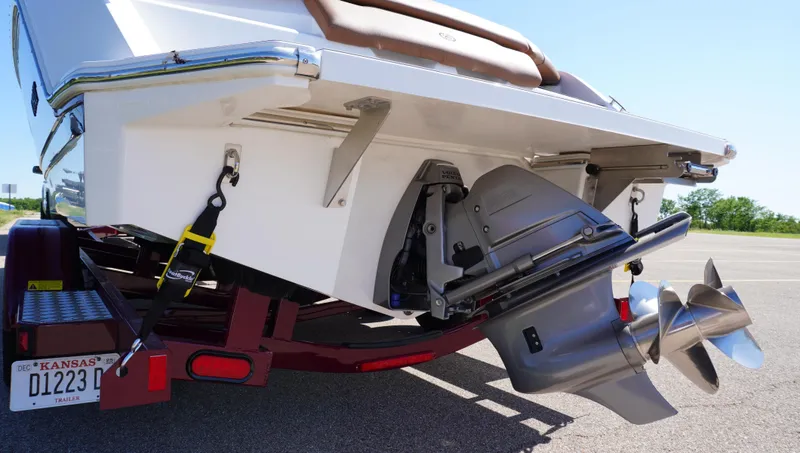 Slide: The Image of 2024 Cobalt CS23 boat on trailer, showing propeller and rear details. - 9