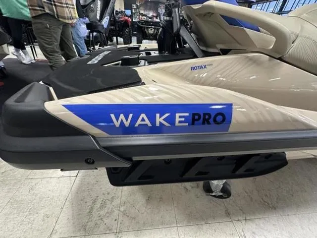 Slide: The Image of 2025 Sea-Doo Waverunner Wake Pro jet ski on display indoors. - 14
