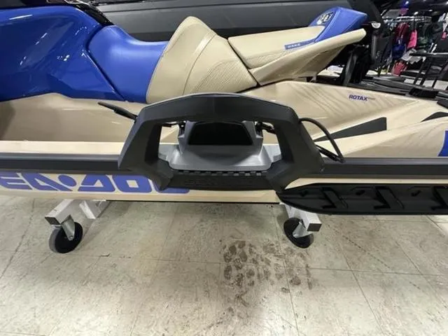 Slide: The Image of 2025 Sea-Doo Waverunner Wake with blue and beige seating on display indoors. - 23