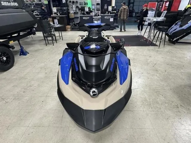 Slide: The Image of 2025 Sea-Doo Waverunner Wake in showroom, featuring sleek blue and black design. - 3