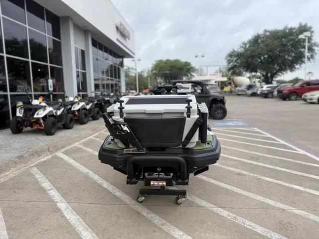 Slide: The Image of 2025 Sea-Doo Waverunner FISH PRO parked outside dealership, showcasing rear storage and design. - 7