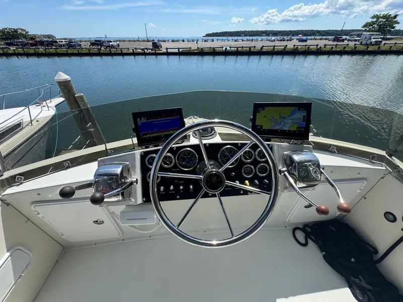 Slide: The Image of 1973 Bertram 28 Sport Fisherman helm with steering wheel, gauges, and navigation screens. - 15