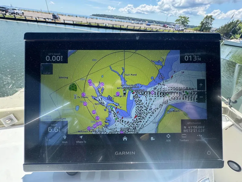 Slide: The Image of Garmin GPS display on a 1973 Bertram 28 Sport Fisherman, showing nautical map and coordinates. - 17