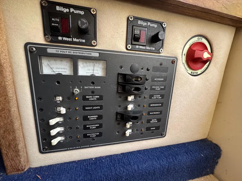 Slide: The Image of 1973 Bertram 28 Sport Fisherman control panel with bilge pump and electrical switches. - 19