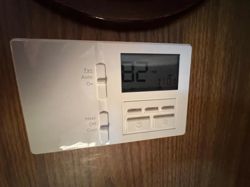 Slide: The Image of Thermostat on 1973 Bertram 28 Sport Fisherman, displaying 82°F, mounted on wooden panel. - 23