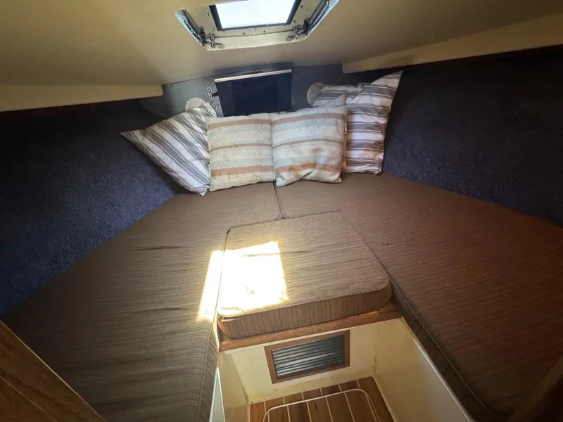 Slide: The Image of 1973 Bertram 28 Sport Fisherman cabin interior with cushions and bedding. - 24