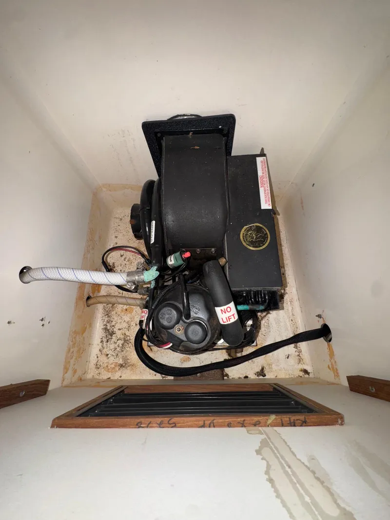 Slide: The Image of 1973 Bertram 28 Sport Fisherman engine compartment with visible machinery and wiring. - 9