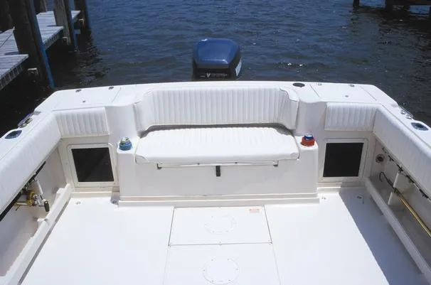 Slide: The Image of 2001 Grady-White Gulfstream 232 boat deck with seating, docked by the water. - 2