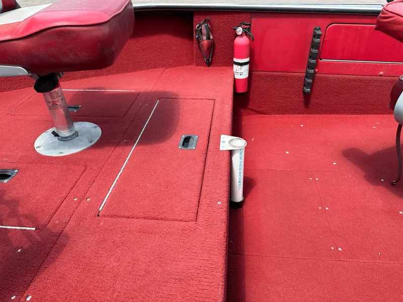 Slide: The Image of Red interior of a 1995 Lund 1660 Pro V Tiller boat with seating and fire extinguisher. - 11