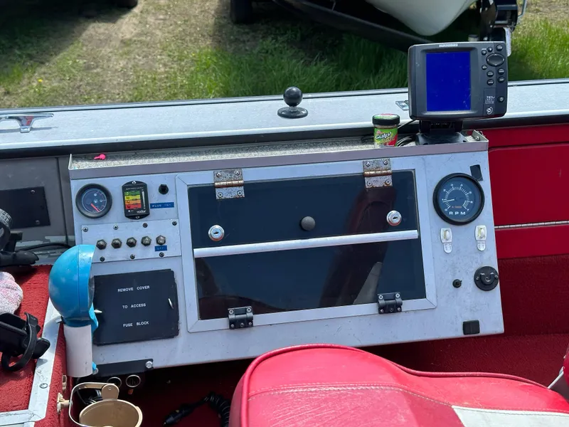 Slide: The Image of Control panel of a 1995 Lund 1660 Pro V Tiller boat with gauges and navigation equipment. - 14