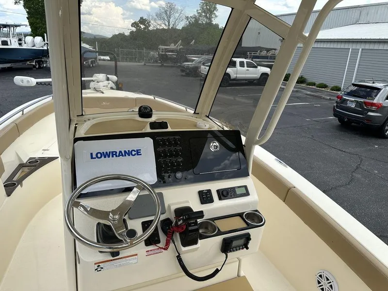 Slide: The Image of 2019 Scout 235 XSF boat dashboard with Lowrance navigation system and steering wheel. - 10