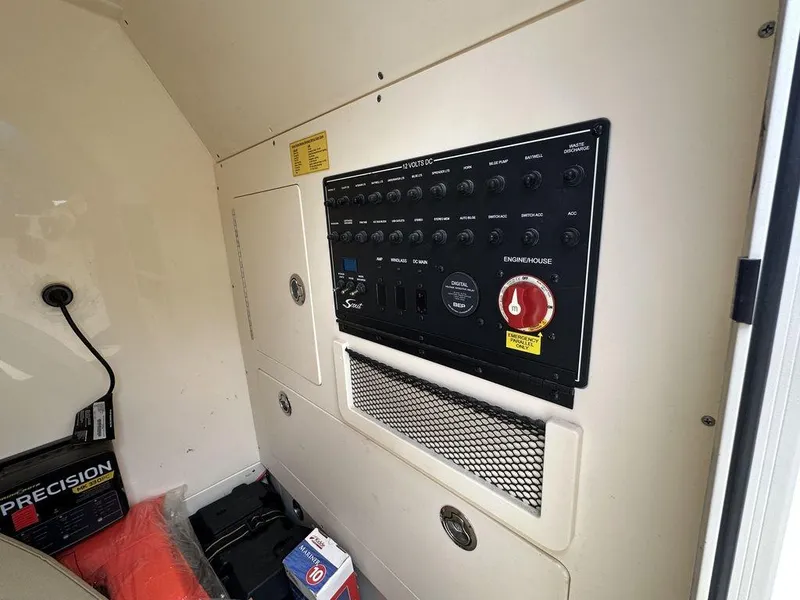 Slide: The Image of 2019 Scout 235 XSF control panel with switches and storage compartments. - 15