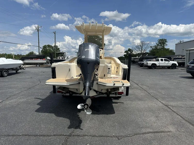 Slide: The Image of 2019 Scout 235 XSF boat with outboard motor in a parking lot. - 5