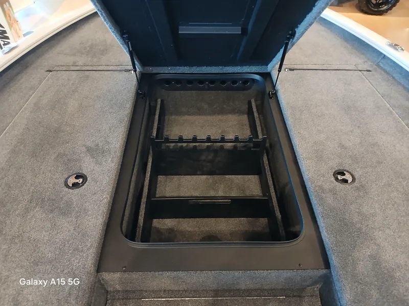 Slide: The Image of Open storage compartment in 2025 Tracker Savage 215 boat, featuring organized interior space. - 10