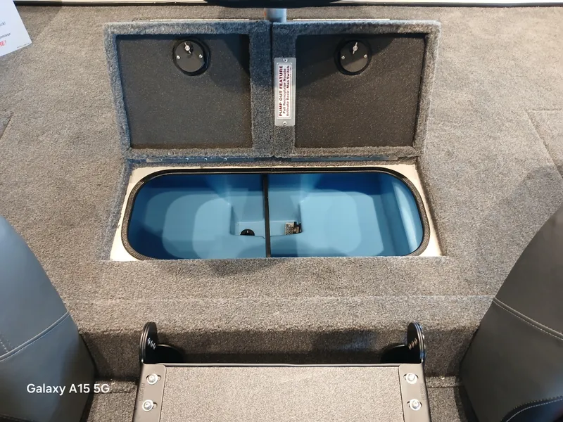 Slide: The Image of Interior view of 2025 Tracker Savage 215 boat with open storage compartment. - 11