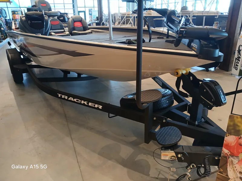 Slide: The Image of 2025 Tracker Savage 215 boat on trailer in showroom setting. - 12