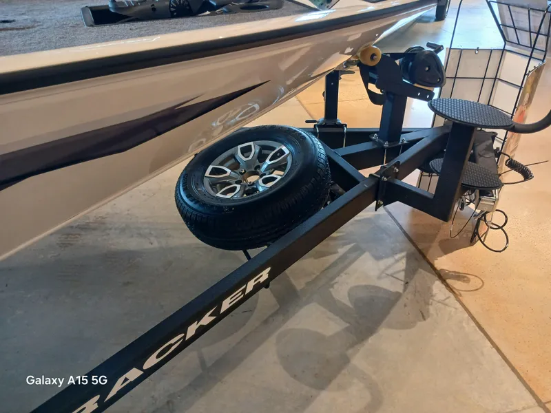 Slide: The Image of 2025 Tracker Savage 215 boat trailer with spare tire and winch system. - 14