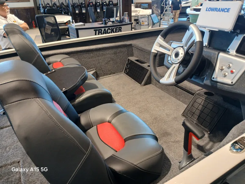 Slide: The Image of Interior of 2025 Tracker Savage 215 boat with steering wheel and seating. - 5