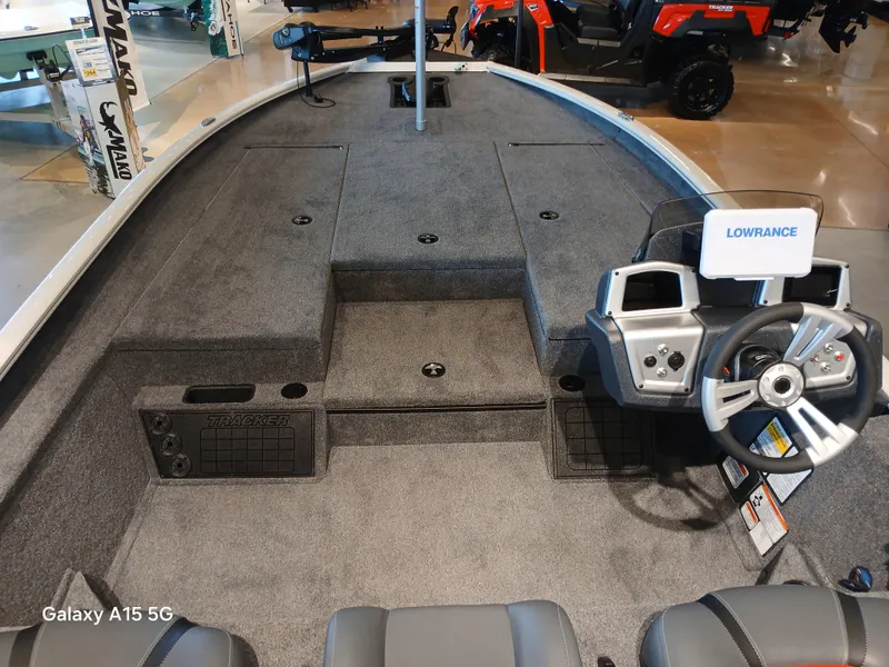 Slide: The Image of 2025 Tracker Savage 215 boat interior with steering wheel and Lowrance navigation system. - 7