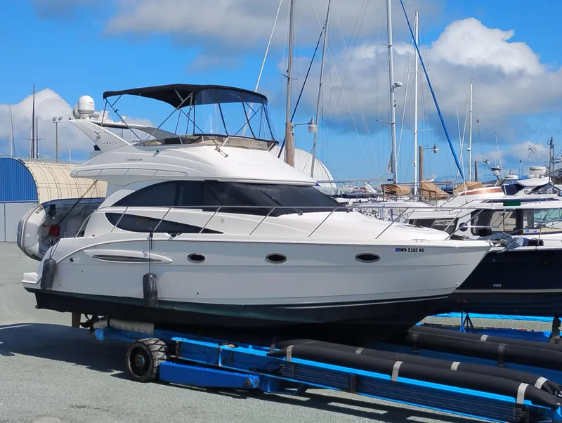 The Image of 2006 Meridian 341 Sedan yacht on trailer at marina, under blue sky. - 0