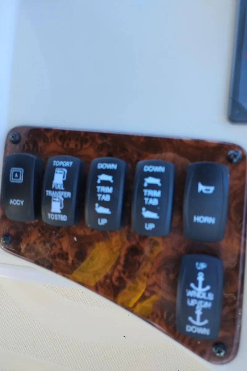 Slide: The Image of Control panel of a 2006 Meridian 341 Sedan boat with various switches. - 14