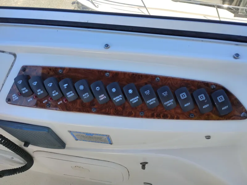 Slide: The Image of Control panel of a 2006 Meridian 341 Sedan boat with labeled switches. - 15