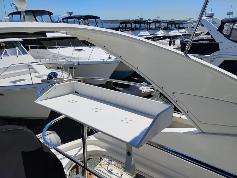 Slide: The Image of 2006 Meridian 341 Sedan yacht with a fishing station, docked among other boats. - 16