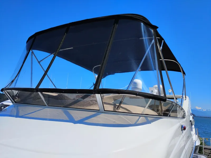 Slide: The Image of 2006 Meridian 341 Sedan boat with black canopy against clear blue sky. - 17