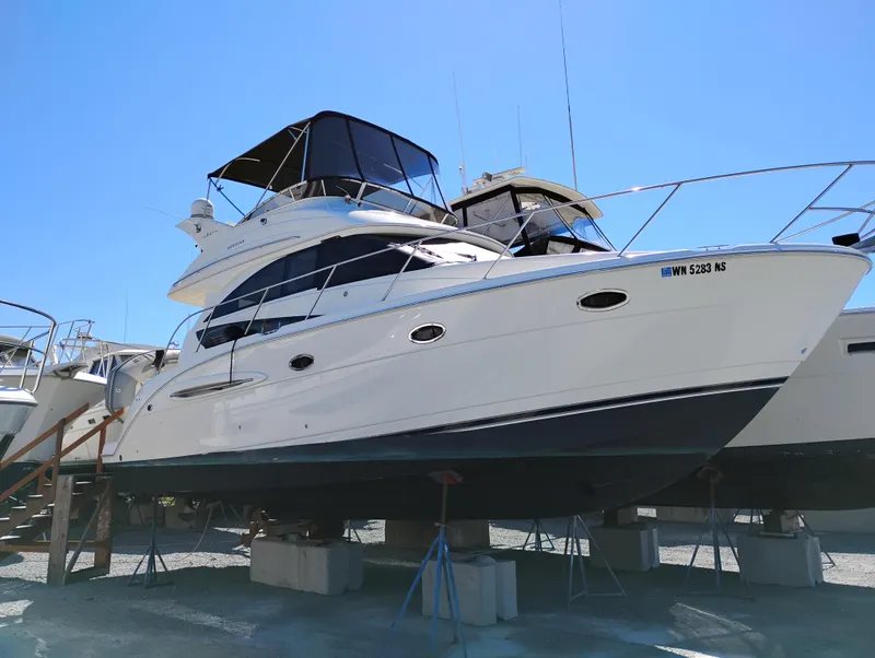 Slide: The Image of 2006 Meridian 341 Sedan yacht on stands, side view under clear blue sky. - 2