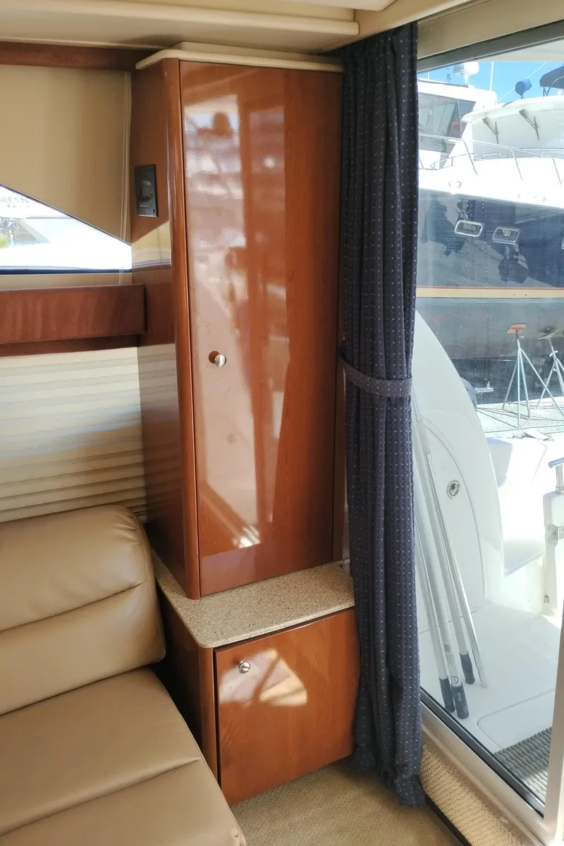 Slide: The Image of Interior of a 2006 Meridian 341 Sedan yacht with wooden cabinetry and leather seating. - 26