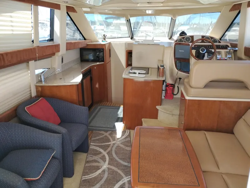 Slide: The Image of Interior of 2006 Meridian 341 Sedan yacht with seating, kitchenette, and helm. - 27