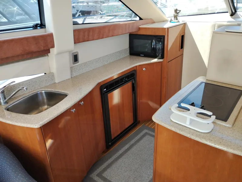 Slide: The Image of 2006 Meridian 341 Sedan yacht kitchen with sink, microwave, and stove. - 29