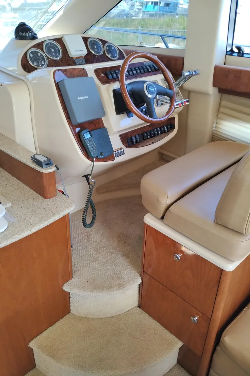 Slide: The Image of 2006 Meridian 341 Sedan helm with wood accents and modern controls. - 35