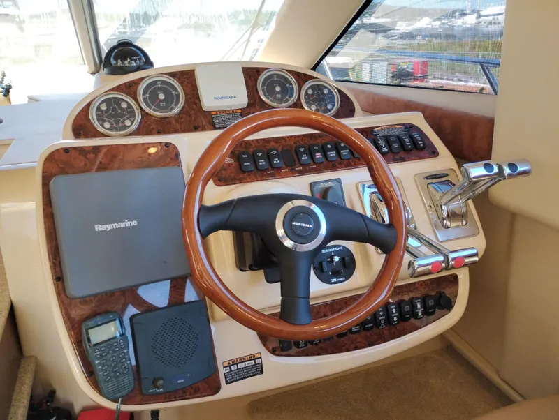 Slide: The Image of 2006 Meridian 341 Sedan helm with wood accents and navigation equipment. - 36