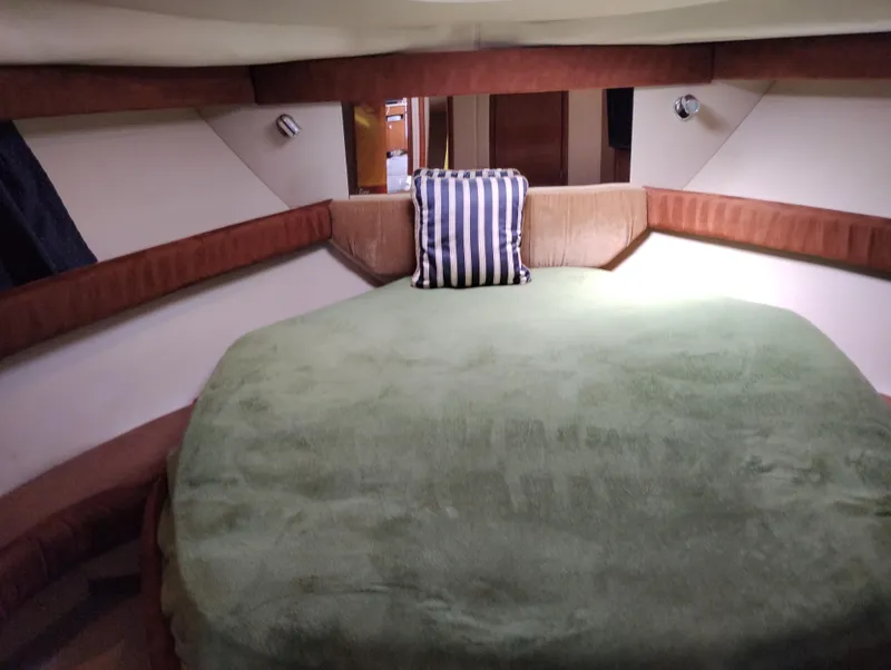 Slide: The Image of Interior cabin of 2006 Meridian 341 Sedan with green bedding and striped pillow. - 46