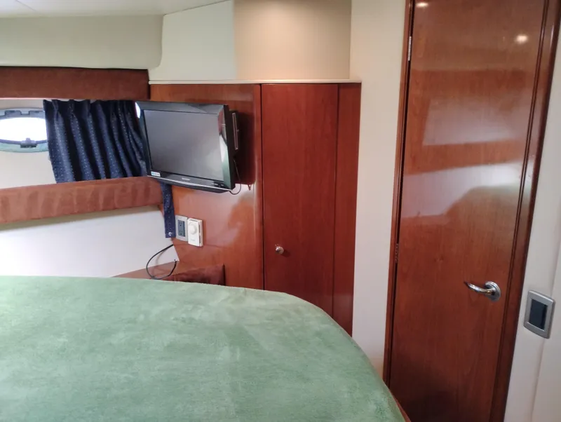 Slide: The Image of Interior of 2006 Meridian 341 Sedan with TV, wood paneling, and green bedspread. - 48
