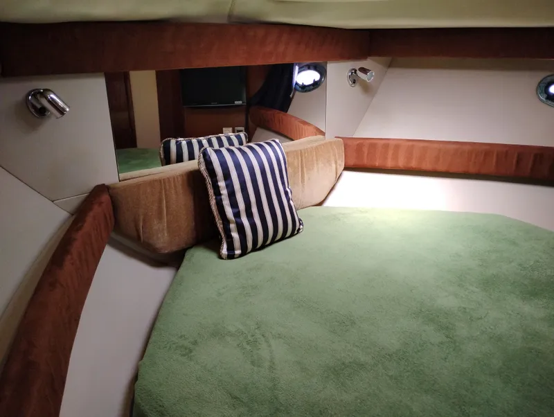 Slide: The Image of Cozy cabin interior of 2006 Meridian 341 Sedan with green bedding and striped pillow. - 49