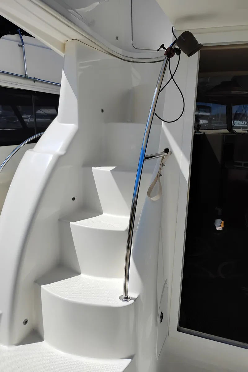 Slide: The Image of Staircase on 2006 Meridian 341 Sedan yacht with sleek white design and metal railing. - 5