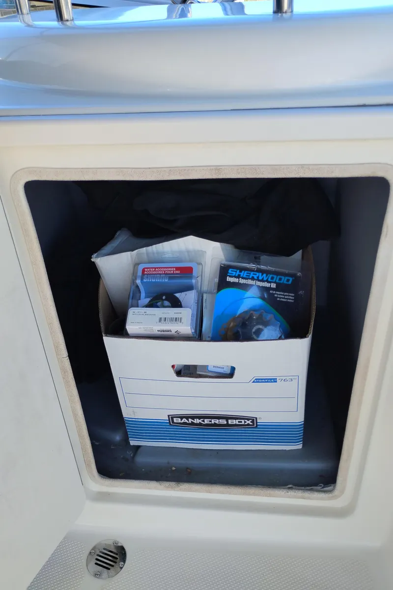 Slide: The Image of Storage compartment on a 2006 Meridian 341 Sedan boat with a box of supplies. - 7