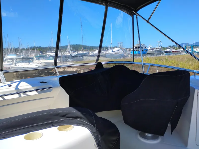 Slide: The Image of 2006 Meridian 341 Sedan interior with marina view, featuring covered seating and clear blue skies. - 8