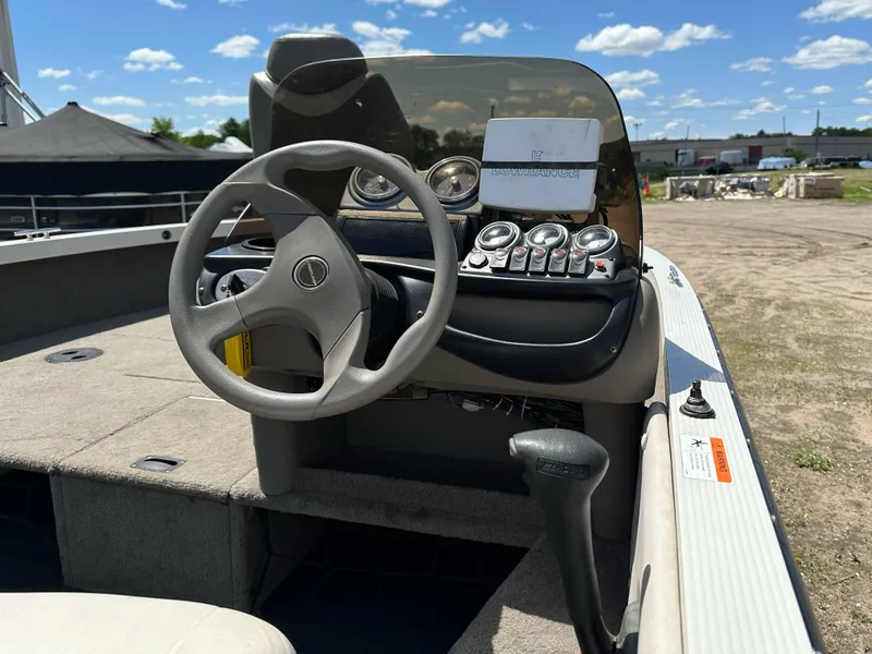 Slide: The Image of 2004 Crestliner 1750 Fish Hawk SC boat interior with steering wheel and control panel. - 10