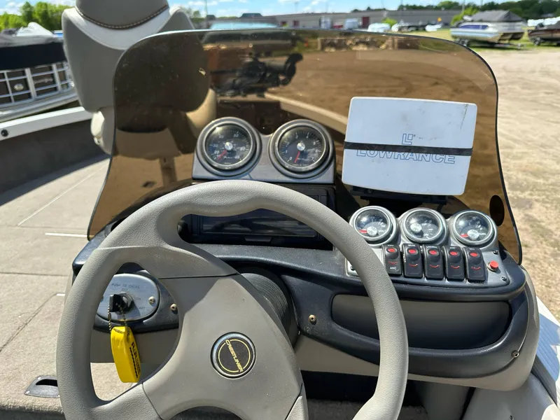 Slide: The Image of 2004 Crestliner 1750 Fish Hawk SC dashboard with steering wheel and gauges. - 11