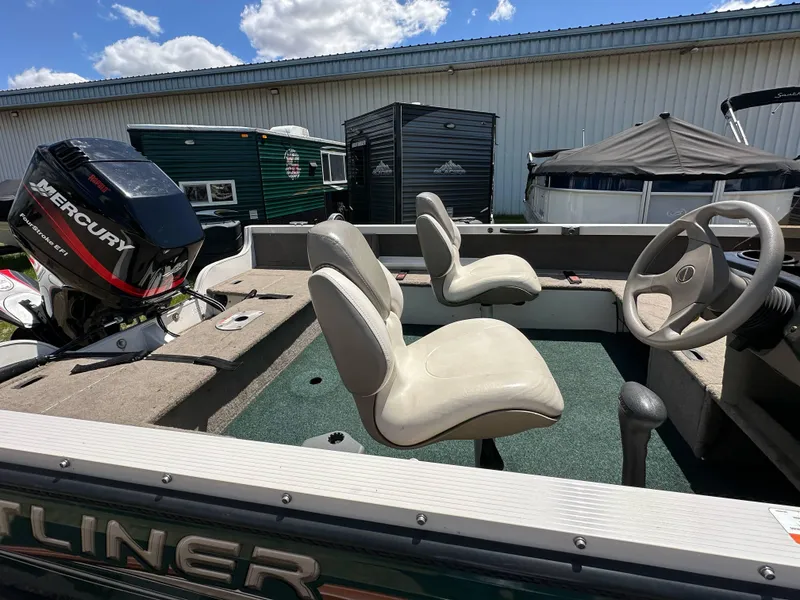 Slide: The Image of 2004 Crestliner 1750 Fish Hawk SC boat interior with seating and Mercury outboard motor. - 12