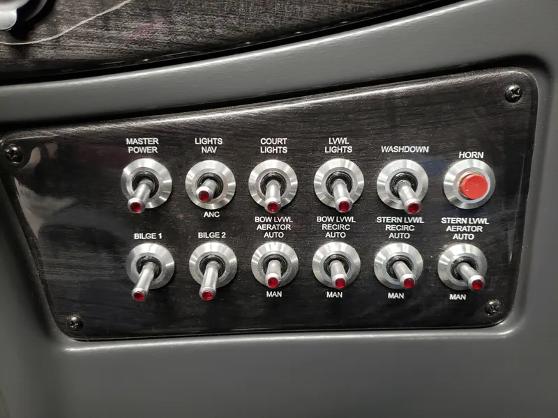 Slide: The Image of Control panel with switches and buttons on a 2024 Warrior 208 boat. - 11