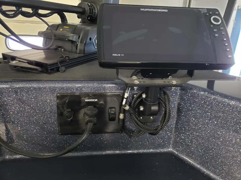 Slide: The Image of 2024 Warrior 208 boat dashboard with Humminbird Helix 10 fish finder. - 14