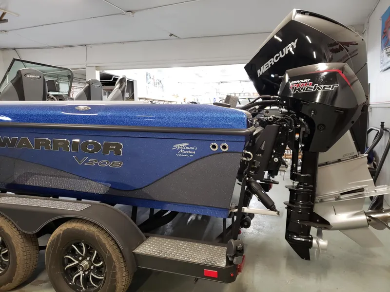 Slide: The Image of 2025 Warrior 208 boat with Mercury outboard motor in showroom. - 4