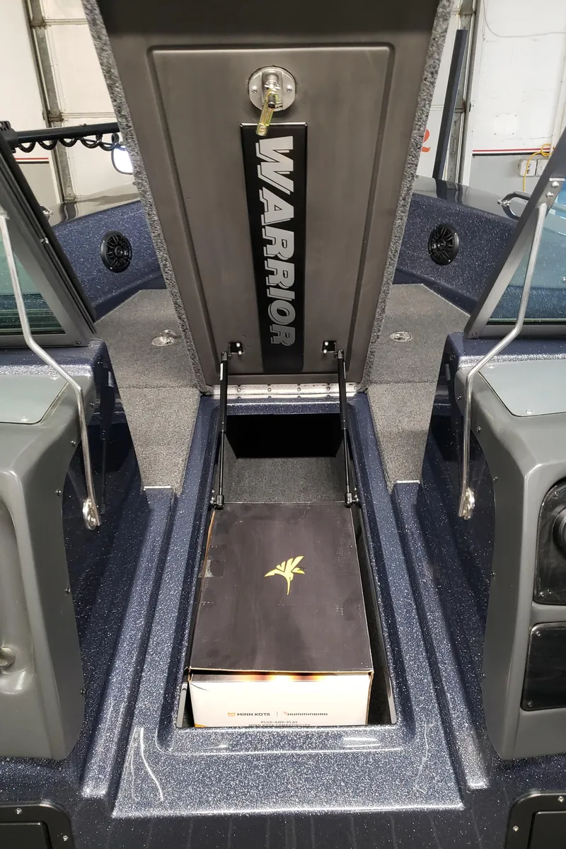 Slide: The Image of 2024 Warrior 208 boat storage compartment with open lid and visible interior. - 9