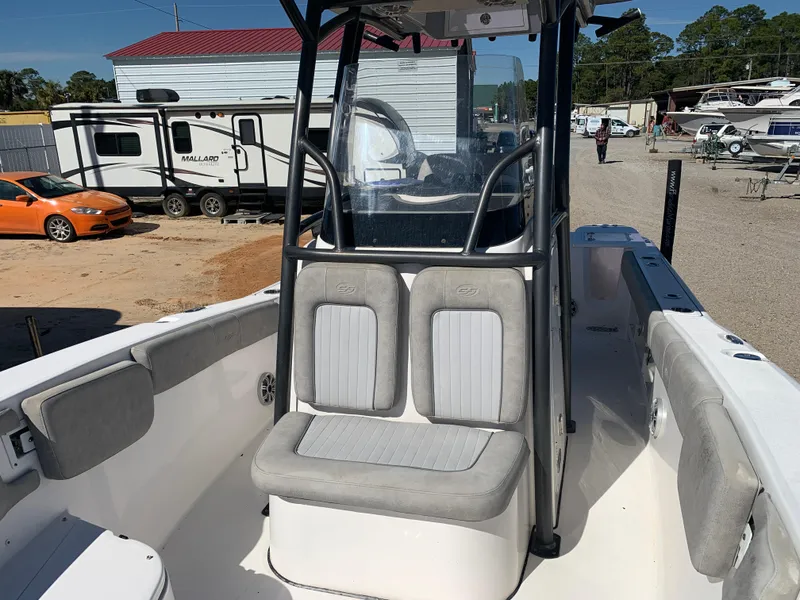 Slide: The Image of 2018 Sea Fox 248 Commander boat with cushioned seating, parked near RVs and vehicles. - 20